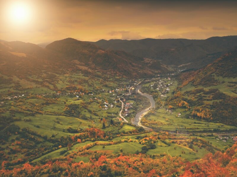 Aerial View: autumn canyon village along the river