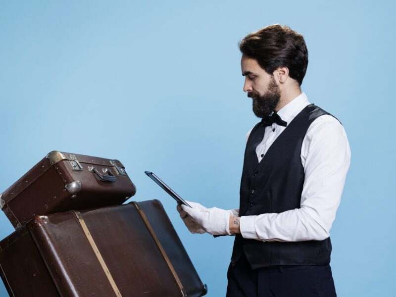 Hotel concierge posing with gadget