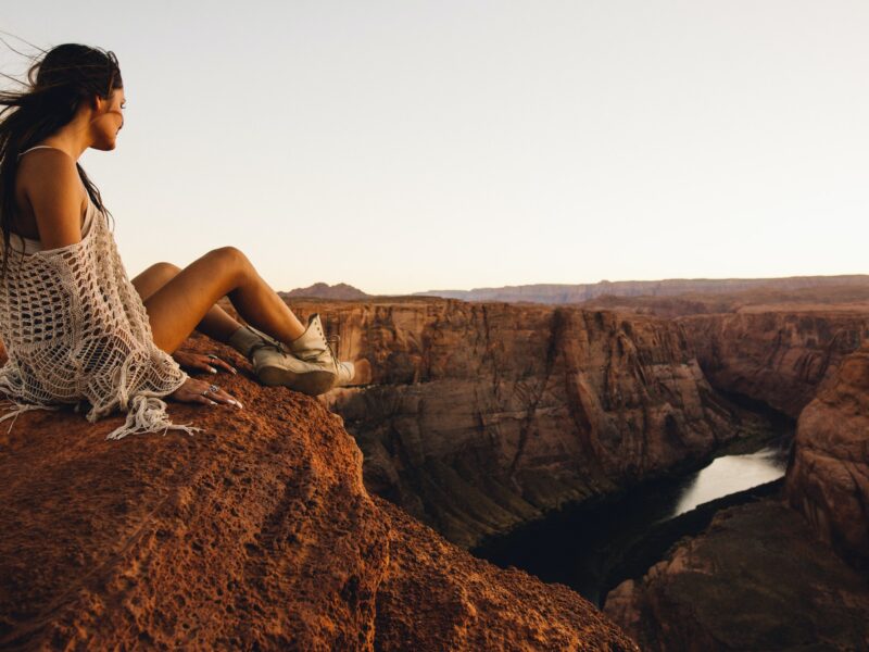 Woman relaxing and enjoying view, Horseshoe Bend, Page, Arizona, USA